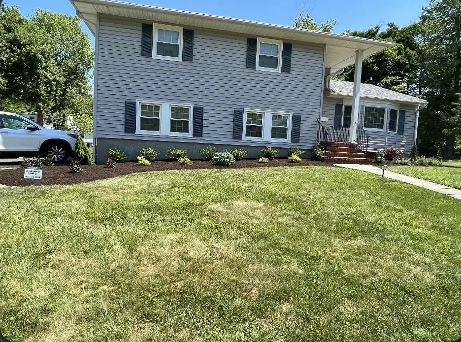 A Manning Landscape & Design front yard project with a freshly landscaped bed and manicured lawn